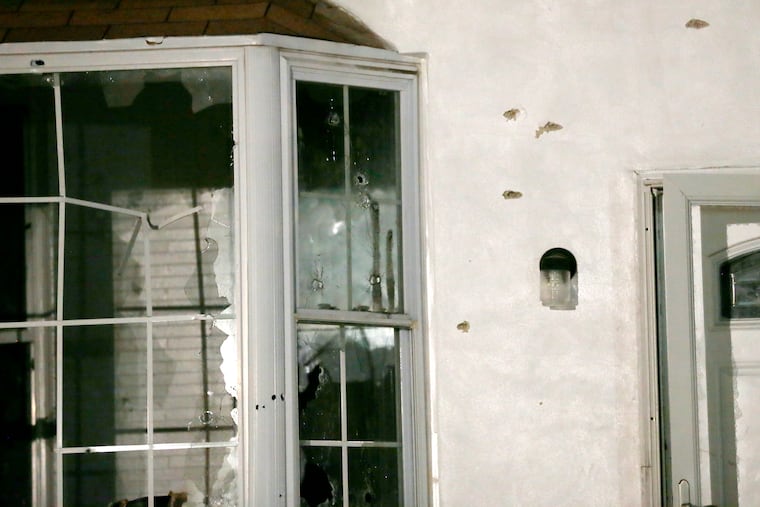 Bullet holes and shot-out windows at Maurice Hill’s home on the 3700 block of North 15th Street after the standoff.