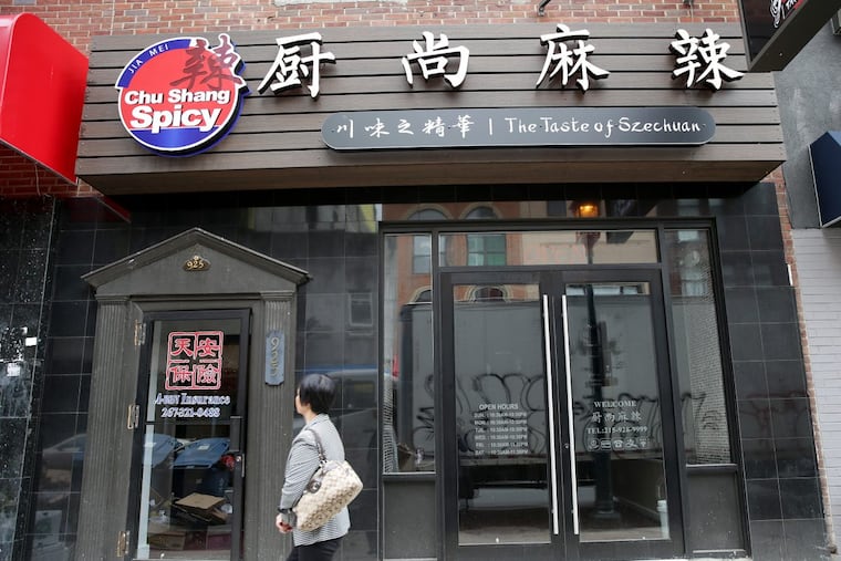 A pedestrian walks by Chu Shang Spicy restaurant at 925 Arch St., Philadelphia.