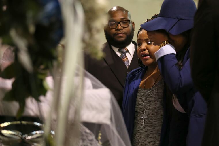 Family members cry during the viewing for 13-year-old Nate Plummer at Tabernacle Church in Camden. Plummer was Camden's first homicide of 2016.