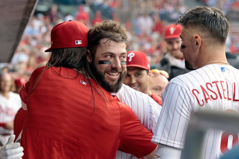 Phillies rookie Weston Wilson looks toward Nick Castellanos as he gets a hug from Brandon Marsh after Wilson hit a home run in his first big league at-bat on Aug. 9