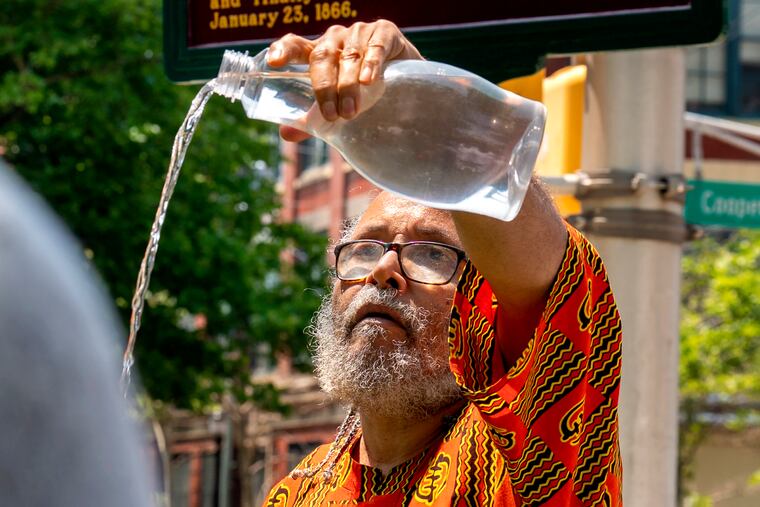 Brother Ransom pours libation during a Juneteenth ceremony in Camden on Sunday, June 18, 2023.