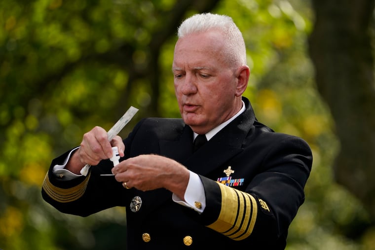 Adm. Brett Giroir, assistant secretary of Health and Human Services, demonstrates the rapid-result COVID-19 test the federal government will send to states during President Donald Trump's announcement of the testing plan in the Rose Garden of the White House, Monday, Sept. 28, 2020, in Washington. (AP Photo/Evan Vucci)