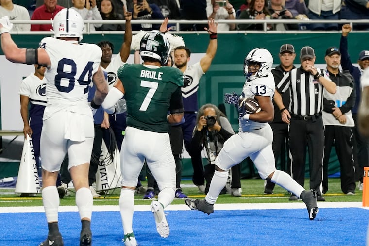 Penn State running back Kaytron Allen (13) scores a touchdown in the first half Friday against Michigan State. It was the Nittany Lions' first TD of the game.