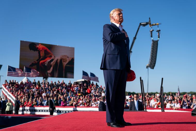 Former President Donald Trump stands while "Justice for All" is played during a campaign rally in Waco, Texas, on March 25, 2023.