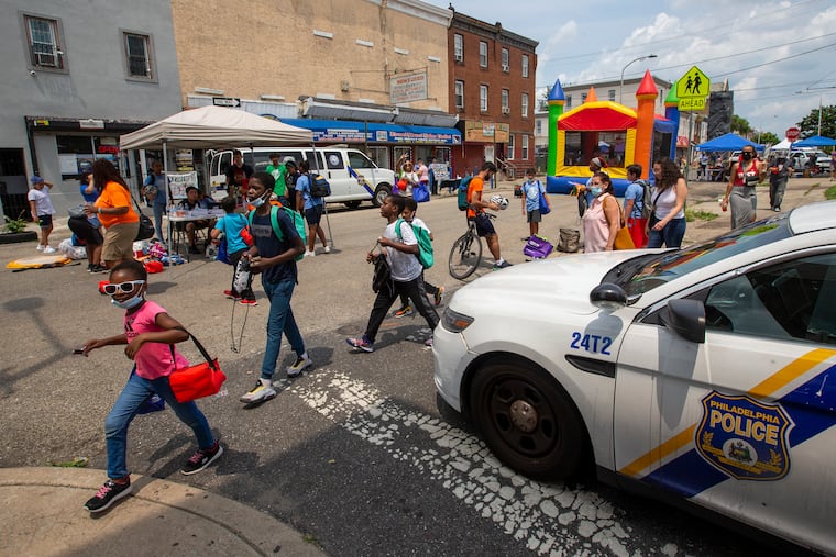 Children make their way along Front St. toward Lehigh Avenue after taking part in the annual Philadelphia Police Block Party. Philadelphia Police, 25th District host a block party along N. Front from Lehigh to Somerset then west to Howard on Thursday, July 15, 2021.