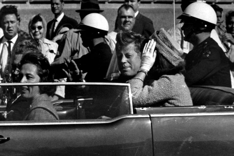 President John F. Kennedy waves from his car in a motorcade approximately one minute before he was shot, Nov. 22, 1963, in Dallas. Riding with President Kennedy are first lady Jacqueline Kennedy, right, Nellie Connally, second from left, and her husband, Texas Gov. John Connally, far left. (AP Photo/Jim Altgens, File)