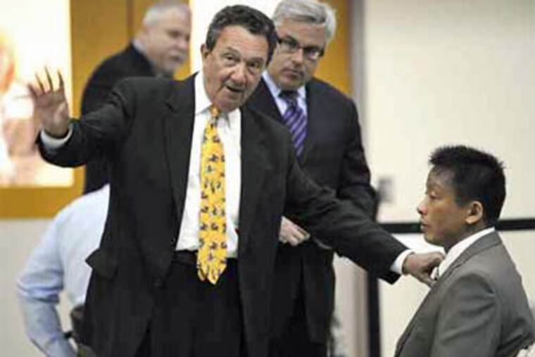 In the moments before testifying before a Senate hearing run by Sen. Arlen Specter (D., Pa.), Gary Kao (right) confers with attorneys Peter Vaira (left) and William Murray. Kao testified that he was being scapegoated. (Bradley C. Bower / Associated Press)