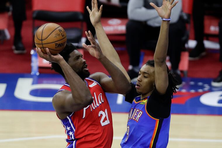 Sixers center Joel Embiid shoots against the Thunder's Moses Brown on Monday.