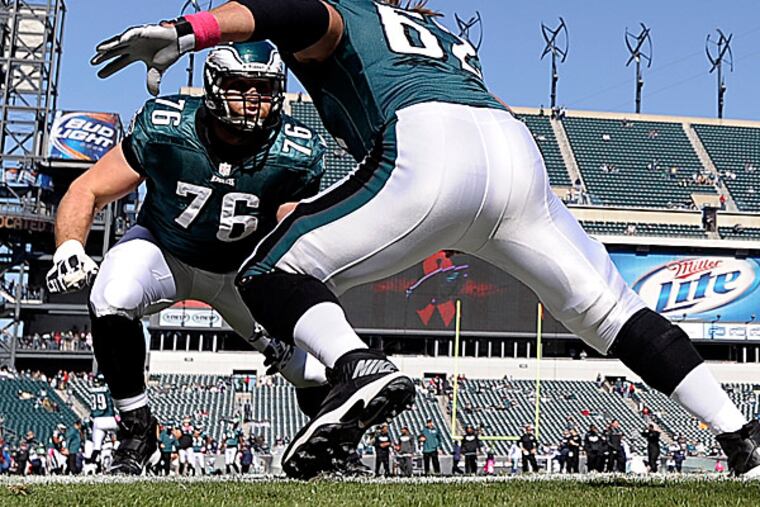 Eagles center Jason Kelce works on his blocking with tackle Allen Barbre. (Michael Perez/AP)