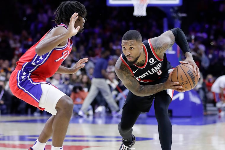 Portland Trail Blazers guard Damian Lillard holds the basketball against Sixers guard Tyrese Maxey on Monday, November 1, 2021 in Philadelphia.