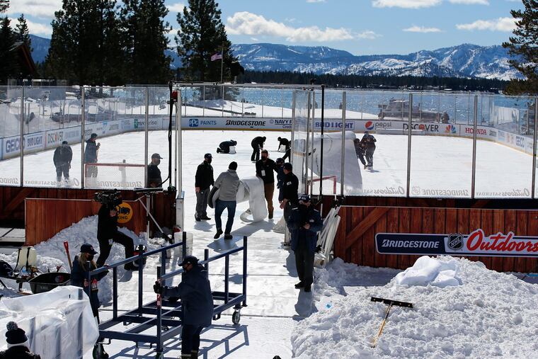 Ice crew members work on the rink along the 18th fairway of the Edgewood Tahoe Resort during the first intermission of Saturday's Vegas-Colorado game. The league suspended play in the afternoon and scheduled it to resume Saturday night.