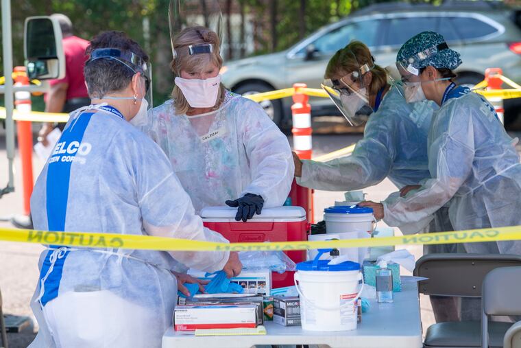 Volunteers provide coronavirus testing for Delaware County residents over 18 at a walk-in site at the parking lot adjacent to the Providence Rehabilitation & Healthcare Center on Mercy Fitzgerald Campus in Yeadon on Thursday.