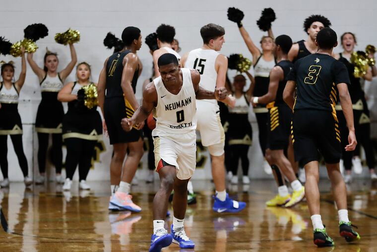 Neumann Goretti High's Hysier Miller, here celebrating after making a three-point basket, scored 24 points to lead the Saints past Archbishop Wood.