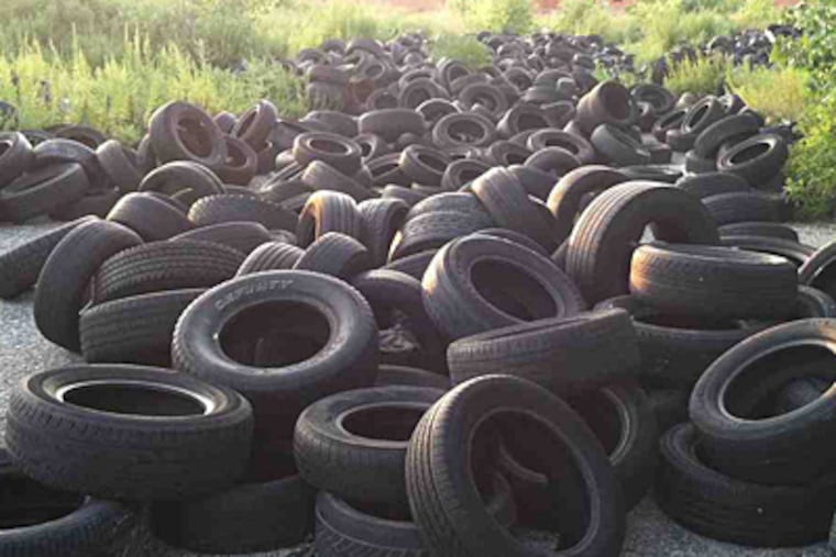 An overgrown lot on Beach Street near Susquehanna Avenue has been taken over by discarded tires. (Phillip Lucas/Staff)