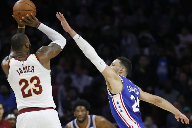 Sixers’ Ben Simmons defends Cavaliers’ LeBron James.