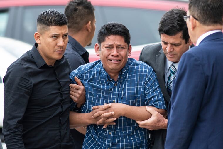 Arnulfo Ochoa, the father of Marlen Ochoa-Lopez, is surrounded by family members and supporters, as he walks into the Cook County medical examiner's office to identify his daughter's body, Thursday, May 16, 2019 in Chicago. (Ashlee Rezin / Chicago Sun-Times via AP)