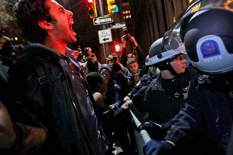 An Occupy Wall Street protester yells at police after being ordered to leave Zuccotti Park, the group's encampment in New York, in 2011.