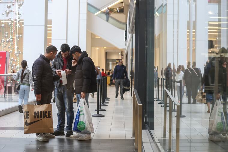 Shoppers can be seen inside the Fashion District by 9th and Filbert St. in Philadelphia on Black Friday, Nov. 24, 2023.