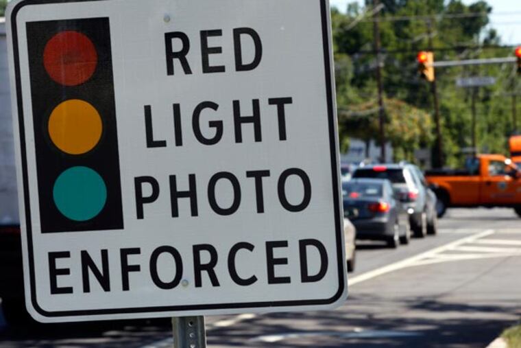 Those controversial red-light cameras, already in use in Philadelphia, New Jersey and elsewhere in the country, could soon make their first appearances in the Philadelphia suburbs. (AP Photo/Mel Evans)