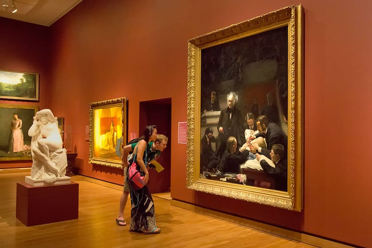 Grant Hayes and Yvette Gonzalez-Quevedo examine Thomas Eakins' "The Gross Clinic" at the Philadelphia Museum of Art.
