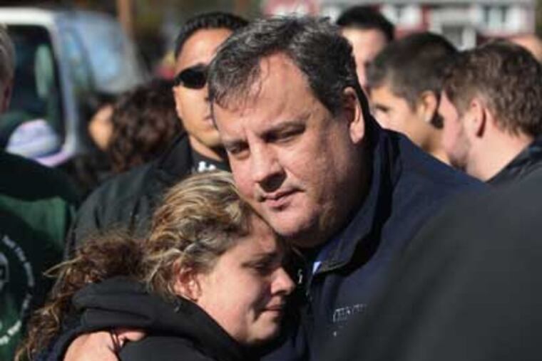 In this Nov. 3, 2012 file photo, New Jersey Gov. Chris Christie comforts Kerri Berean in Little Ferry, N.J., after Superstorm Sandy caused a tidal surge on the Hackensack River that overtook a natural berm protecting the town. (AP Photo/The Star-Ledger, David Gard, Pool, File)