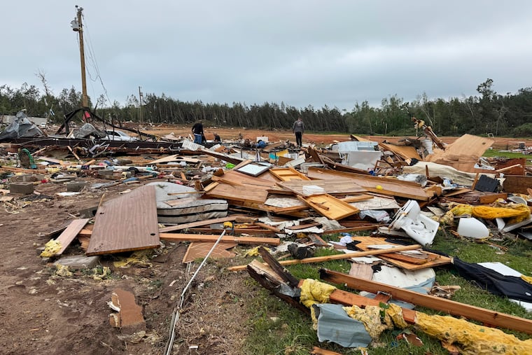 A tornado left most of the two dozen homes at Gene’s Mobile Home Supply flattened into heaps of splintered boards and twisted metal Thursday in Bogue Chitto, Miss.