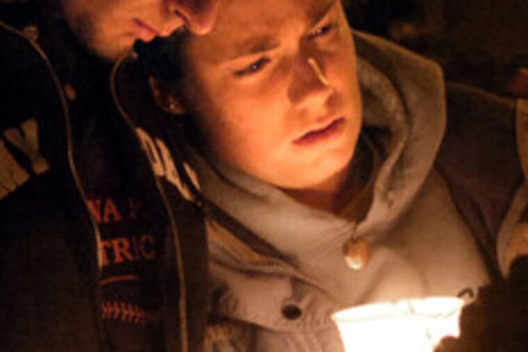 Seeking comfort during a vigil at the University of Illinois on Wednesday.