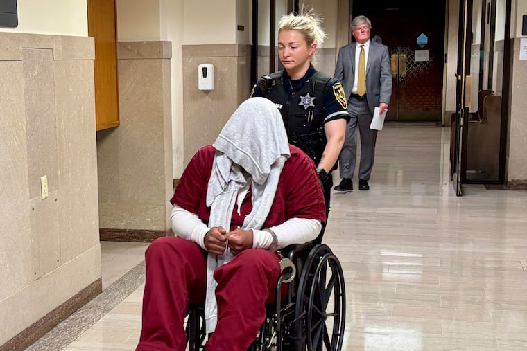 Tyreese Quinerley covered his face with a towel as he was escorted out of a courtroom in the Montgomery County Courthouse on Wednesday. Quinerley was sentenced to 18 to 40 years in prison for third-degree murder.