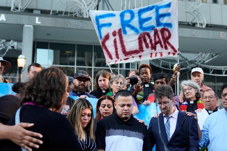 Jennifer Vasquez Sura (front left), her husband Kilmar Abrego Garcia (front center), and Attorney Simon Sandoval-Moshenberg (front right) attend a protest rally at the Immigration and Customs Enforcement field office in Baltimore on Monday, Aug. 25, 2025.