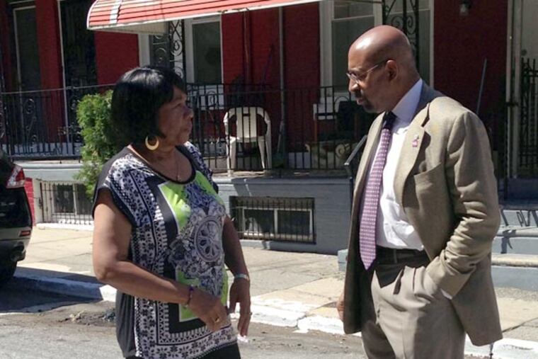 Mayor Nutter and Sydenham Street block captain Maggie Werts talk about the condition of the street. HELEN UBINAS / DAILY NEWS STAFF