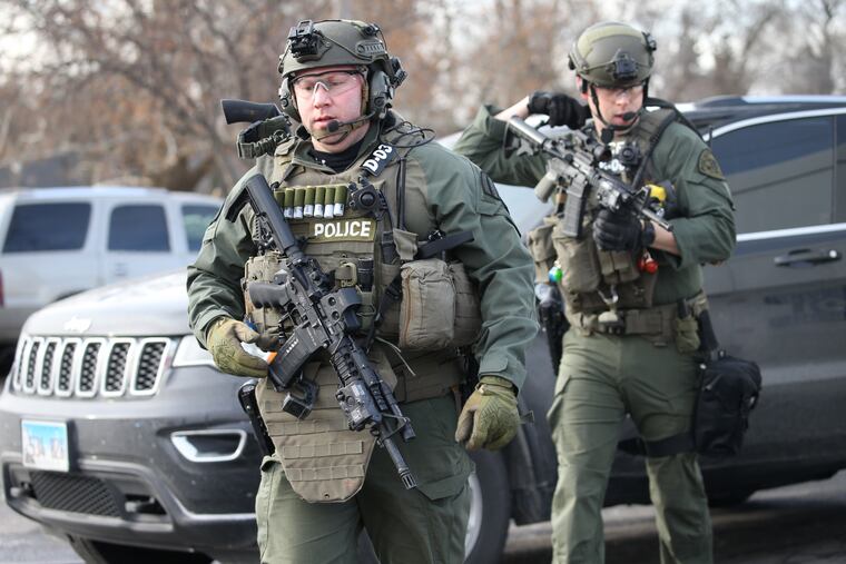 Police officers armed with rifles stage near a commercial building where an active shooter was reported in the 600 block of Archer Avenue in Aurora, Ill., Feb. 15, 2019. (Antonio Perez / Chicago Tribune / TNS)