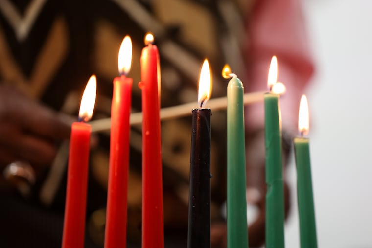 The kinara is lit during the candle lighting ceremony at Omega Psi Phi Fraternity Inc. on Saturday, Dec. 27, 2025, in Philadelphia. The kinara is a seven-branched candleholder that symbolizes the seven principles of Kwanzaa.