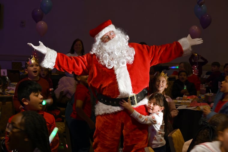 The man of the hour gets lots of hugs during the 70th Annual Archbishop’s Benefit for Children, a Catholic Charities of Philadelphia event funded by a grant from the Riley Family Foundation.