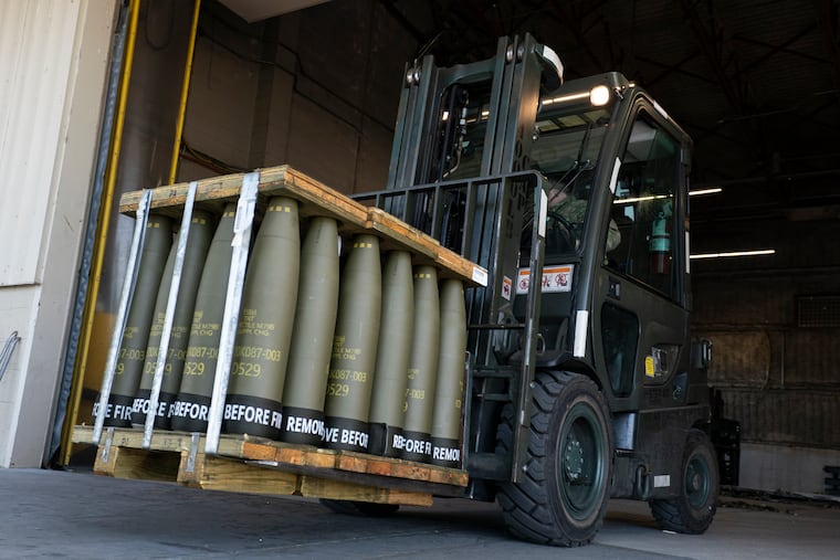 Airmen with the 436th Aerial Port Squadron use a forklift to move 155 mm shells ultimately bound for Ukraine in 2022 at Dover Air Force Base, Del.