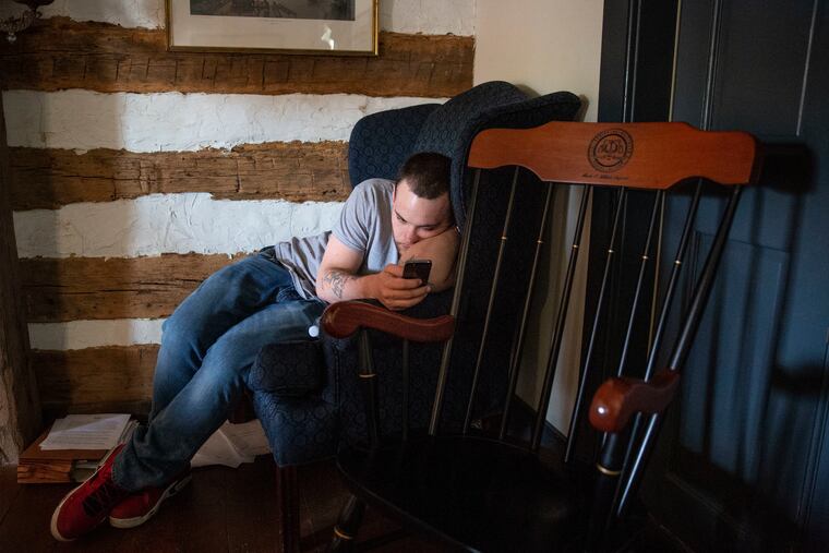Ian Cain looks at his phone in Harrisburg, PA on April 25, 2019. Cain was 17 years old in 2009 when he left the Glen Mills Schools. He says he was beaten by counselors for things like saying "yeah" instead of "yes."