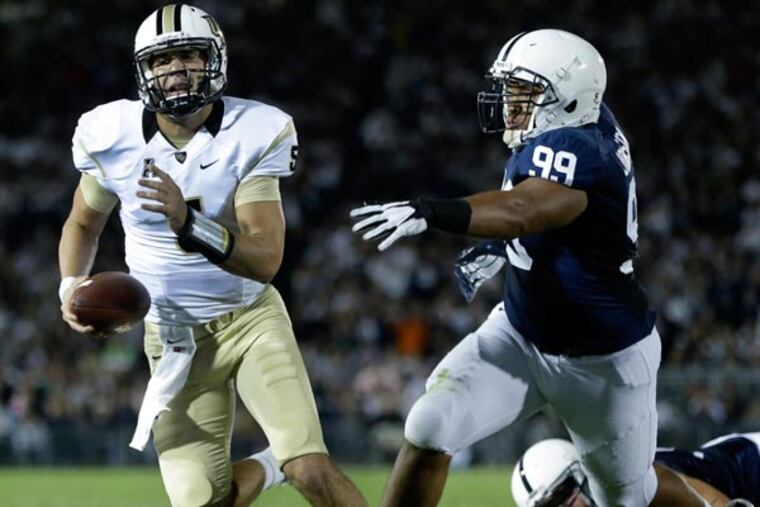 Central Florida quarterback Blake Bortles (5) scrambles past Penn St defensive tackle Austin Johnson (99) to the 1-yard line during the third quarter of an NCAA college football game in State College, Pa., Saturday, Sept. 14, 2013. UCF won 34-31. (Gene J. Puskar/AP)