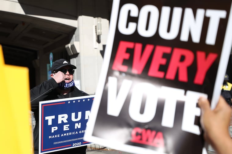 Trump supporter clashes with “Count Every Vote” protesters while making a crying gesture outside of the Pennsylvania Convention Center in Philadelphia on Thursday, Nov. 05, 2020.