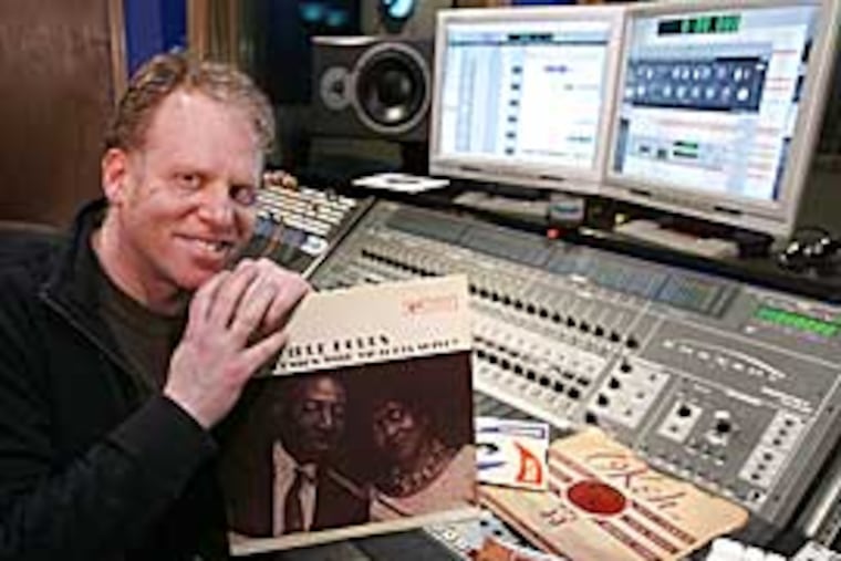 Blues guitarist Lonnie Johnson is the subject of a tribute album featuring Philadelphia musicians that has been produced by Aaron Levinson. He is shown with some of his Lonnie Johnson records in Range Recording Studio in Ardmore. (Charles Fox / Inquirer)