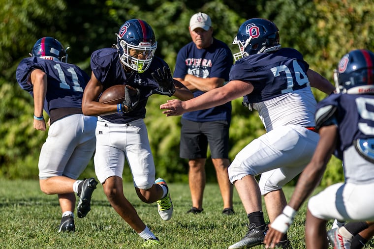 Keon Powell runs with the ball at a Cardinal O’Hara High practice on Thursday.