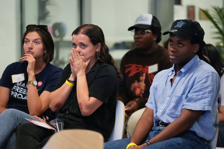 People react as they watch the debate between President Joe Biden and his Republican rival, former President Donald Trump, at a watch party organized by the Miami Freedom Project at the Center for Black Innovation in Overtown, Miami, Thursday, June 27, 2024. (AP Photo/Rebecca Blackwell)