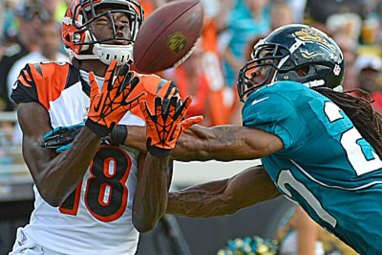 Bengals wide receiver A.J. Green catches a pass in front of Jaguars cornerback Rashean Mathis. (Phelan M. Ebenhack/AP)
