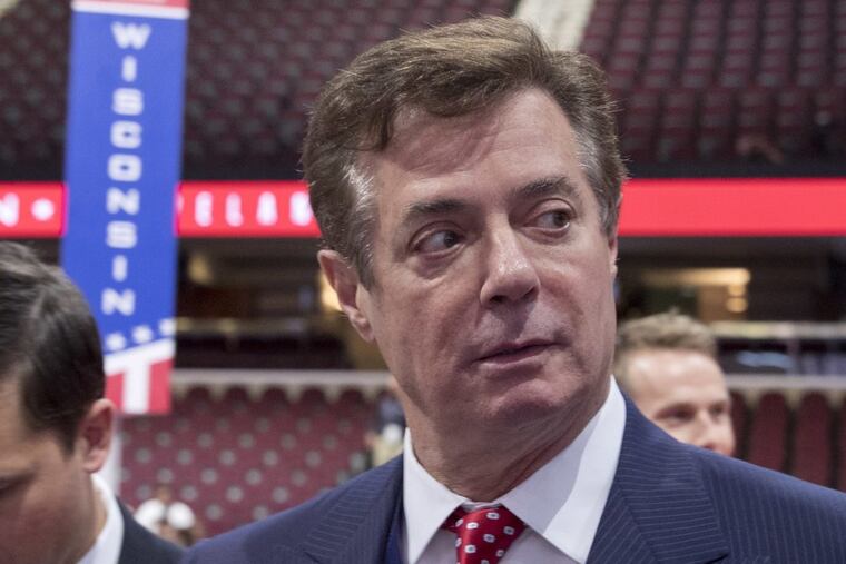 Trump campaign chairman Paul Manafort walks around the convention floor before the opening session of the Republican National Convention in Cleveland last year.