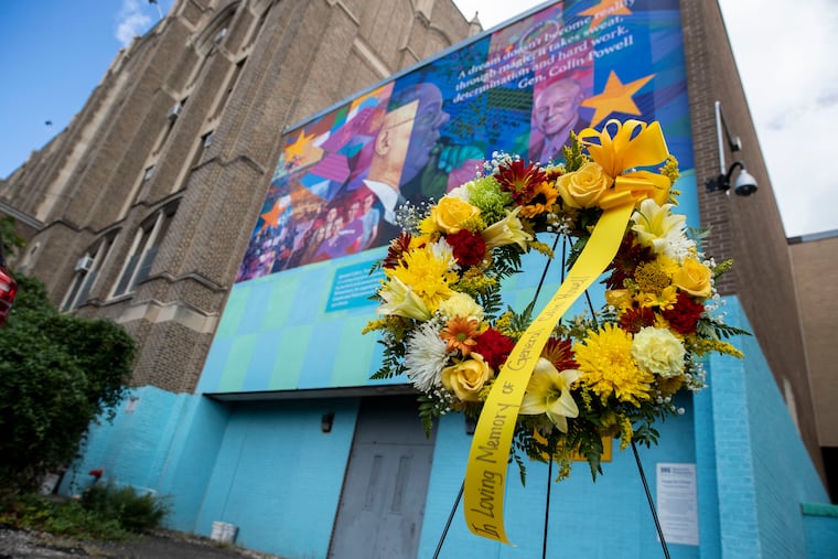 "Engage the Change," a mural by Ernel Martinez, features the image of Colin Powell at Olney Charter High School. Aspira provided the memorial flowers.