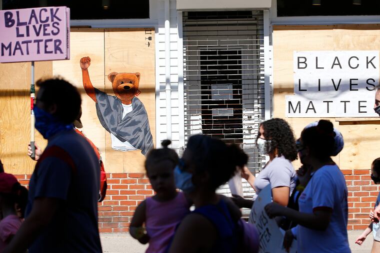 Children and adults march along South Fourth Street toward Jefferson Square Park in South Philadelphia during a Children's March for Justice on Saturday, June 13, 2020.