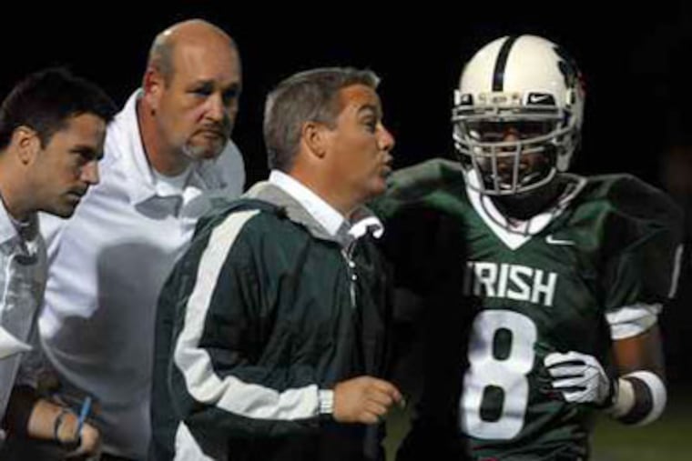 Rick Brown (second from right) was fired after six seasons as Camden Catholic's football coach. (Tom Gralish / Staff Photographer)