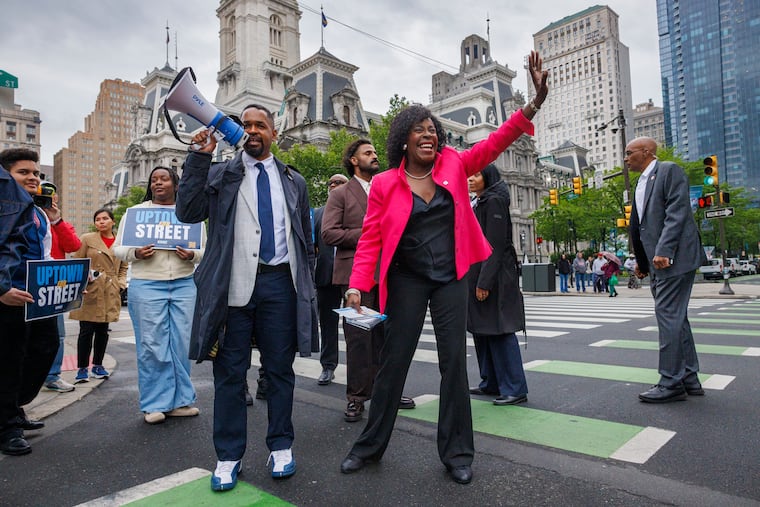 State Sen. Sharif Street and Mayor Cherelle L. Parker (right) greet commuters on May 14 as he campaigns for Congress outside City Hall.