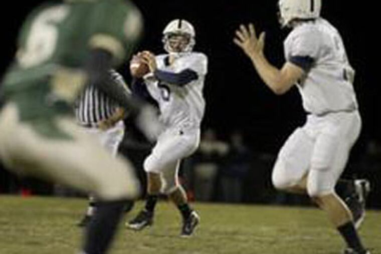 Shawnee's Chris LaPierre (right) motions to quarterback Kody Smith for the ball as Camden Catholic's Damiiri Pettigrew runs in from the left. Smith made the most of his few passing opportunities, completing 5 of 10 passes for 143 yards.