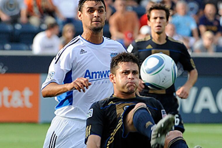 Union defenseman Cristian Arrieta does a bicycle kick in front of San Jose Earthquakes forward Chris Wondolowski. (AP Photo/Barbara Johnston)