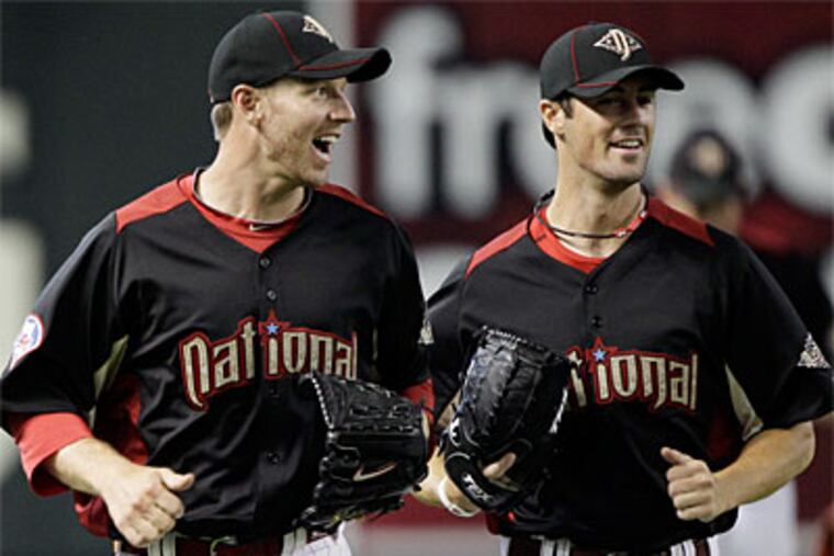 Phillies pitchers Roy Halladay (left) and Cole Hamels participate in an All-Star Game practice. (AP Photo / David J. Phillip)