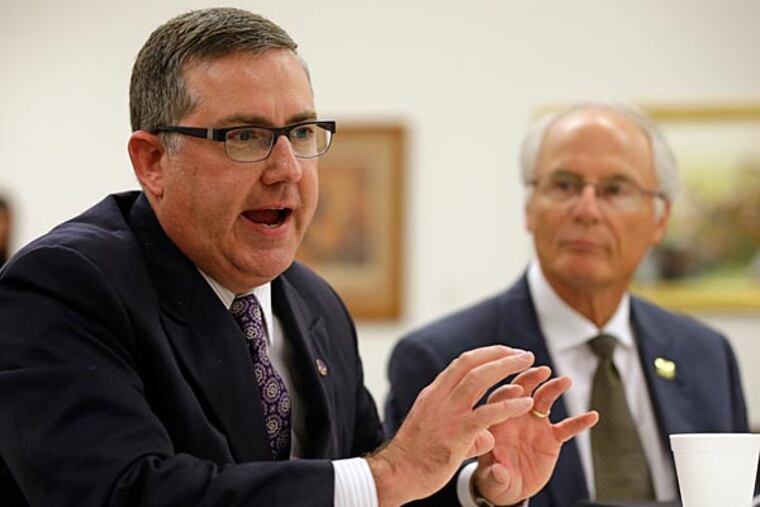 Wright State University president David R. Hopkins, right, listens as Kansas State University president Kirk Schulz, left, discusses changes to the NCAA structure after a board of directors vote at NCAA headquarters in Indianapolis, Thursday, Aug. 7, 2014. The NCAA Board of Directors overwhelmingly approved a package of historic reforms Thursday that will give the nation's five biggest conferences the ability to unilaterally change some of the basic rules governing college sports. (Michael Conroy/AP)